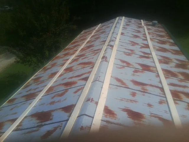 Rusted metal roof panels with new wood purlins before replacement — Storm Damage Roof Repair in Montvale by Roofing Brothers